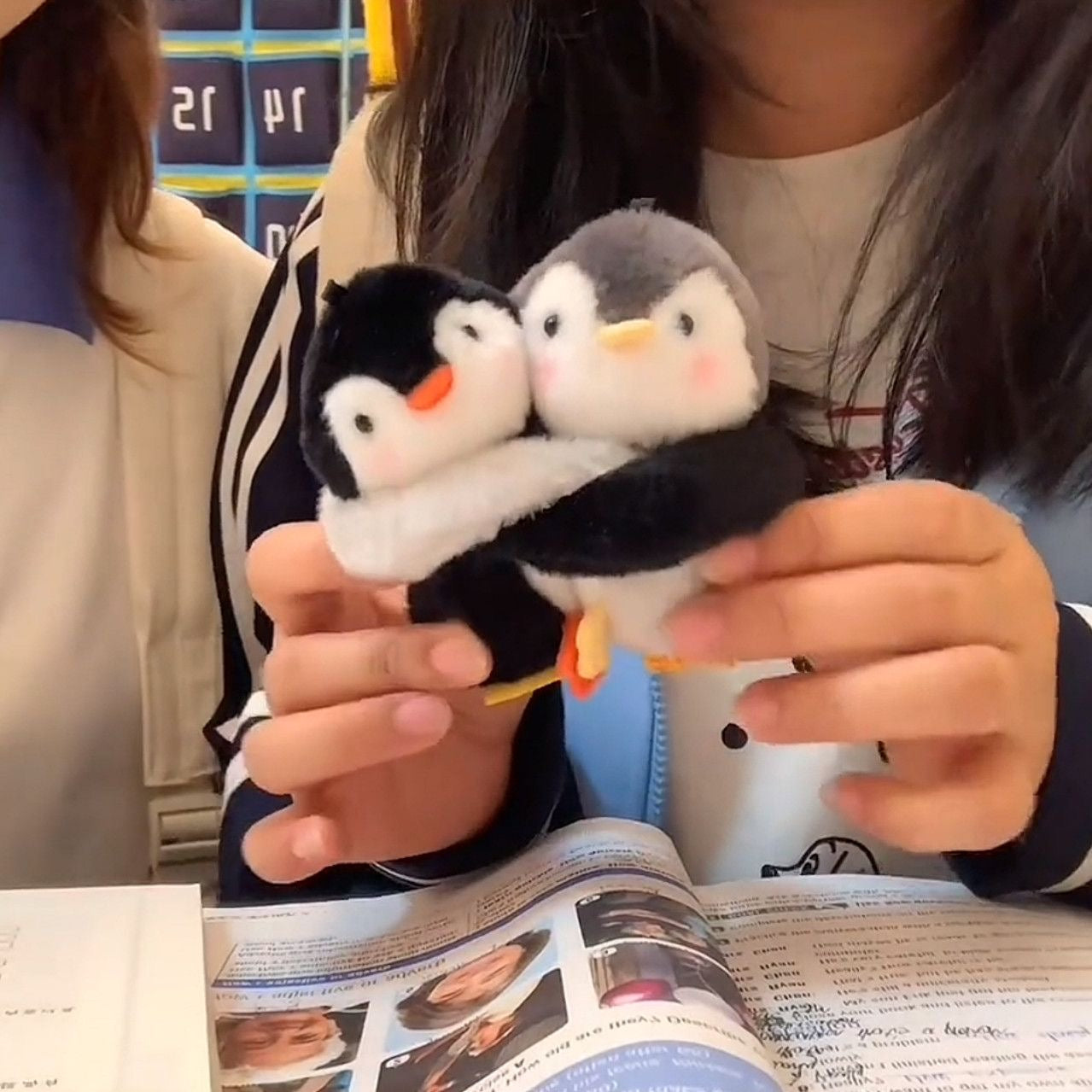 Hugging penguin plush charm