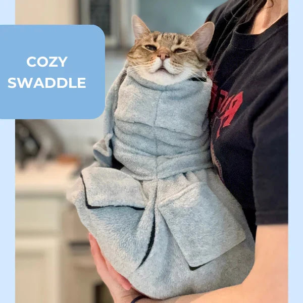 Cat snugly wrapped in a soft grooming swaddle, ready for a calm nail trim