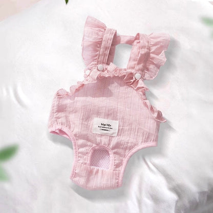 Pink baby romper with ruffled details on a white background