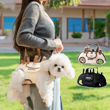 Person holding a small white dog in a beige pet carrier with 'HIPPET' branding, set against a blurred outdoor background.