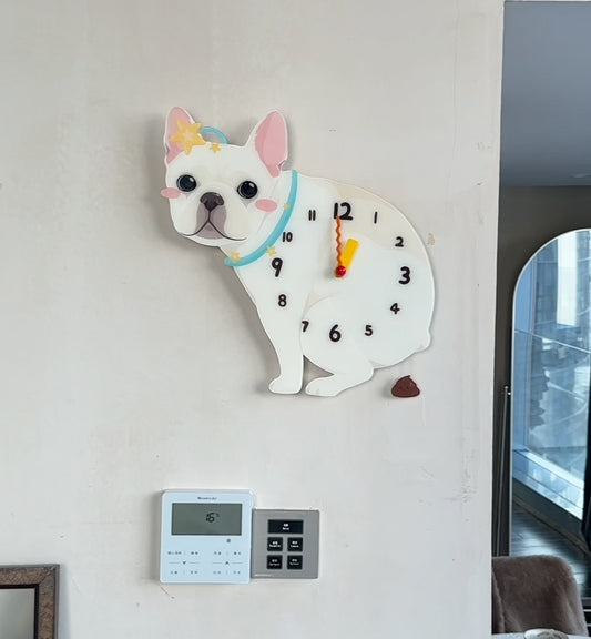 Wall clock shaped like a dog with a colorful bow tie on a white wall.