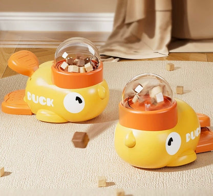 Two yellow duck-shaped toys with transparent tops on a beige carpet.