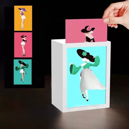 White card holder with illustrations of women in hats and dresses, with a hand placing a card inside.