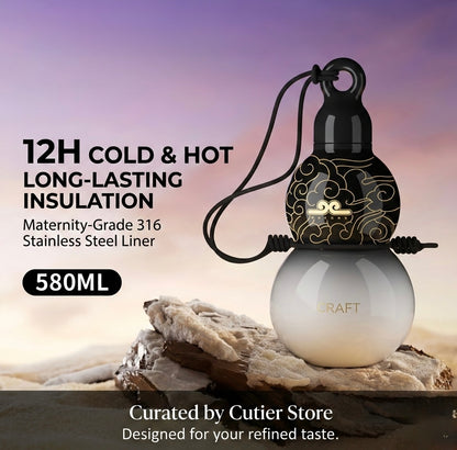 Two insulated bottles with a decorative top on a rock, against a blurred natural background.
