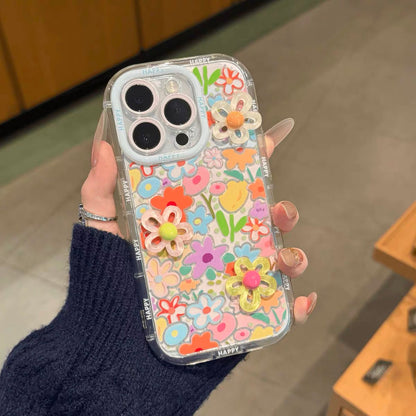 Colorful floral phone case held by a person with a blurred background