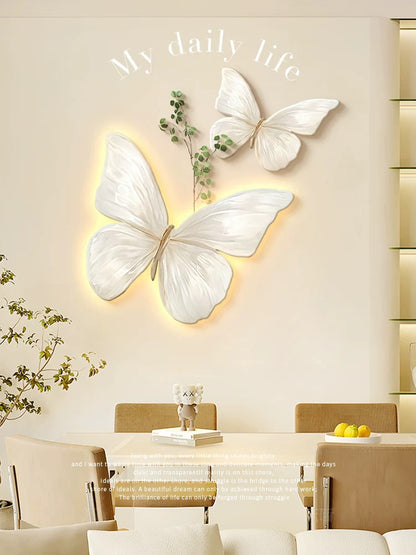 Butterfly wall lights on a wall with a dining table and chairs in the background.