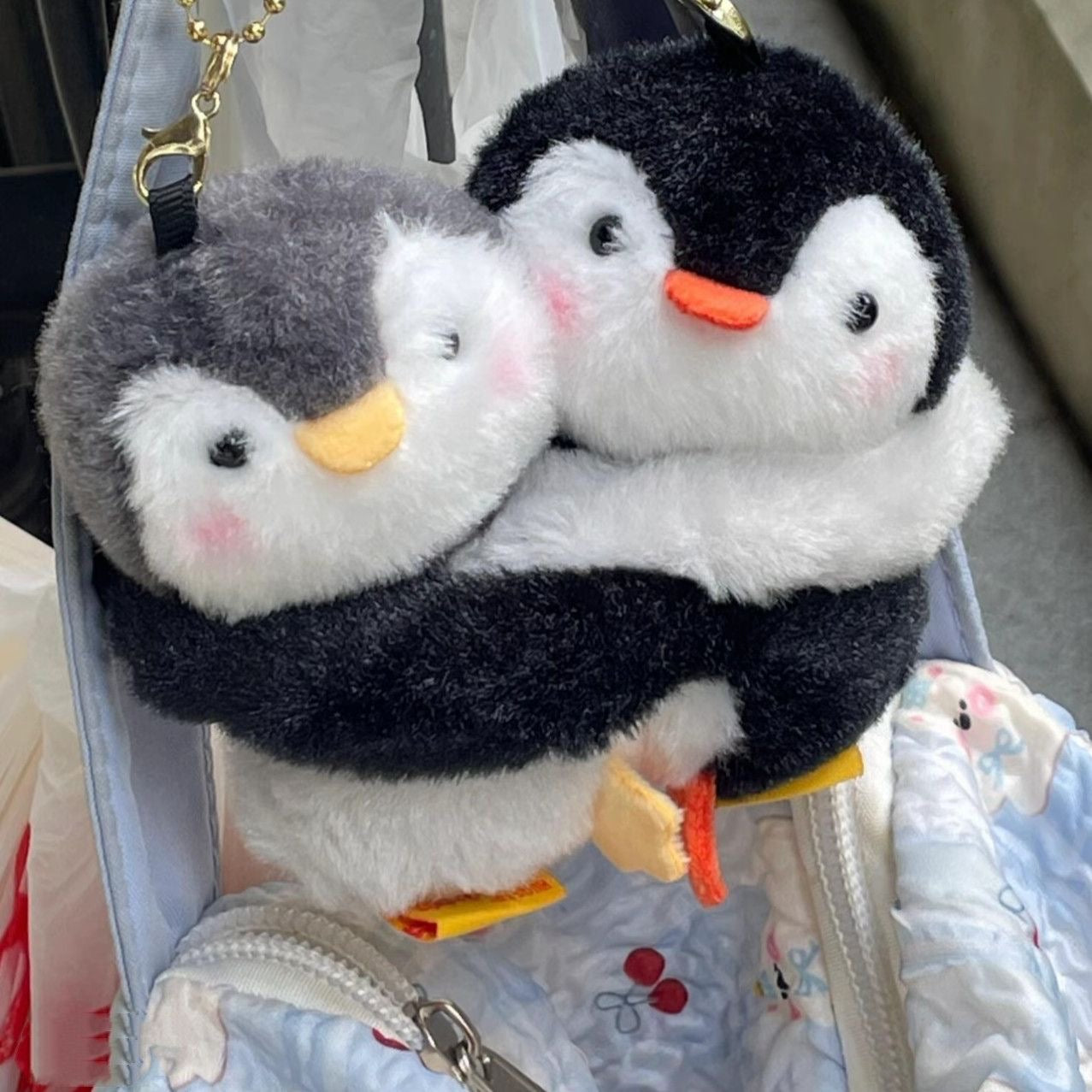 Hugging penguin plush charm