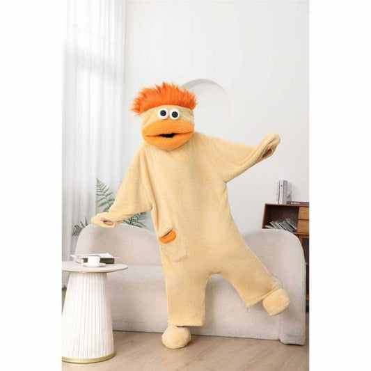 Person wearing a beige onesie with orange hair in a room with a white curtain and small table.