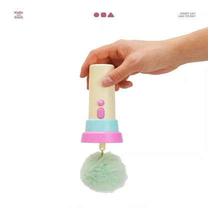 Hand holding a colorful cat toy with a pom-pom on a white background