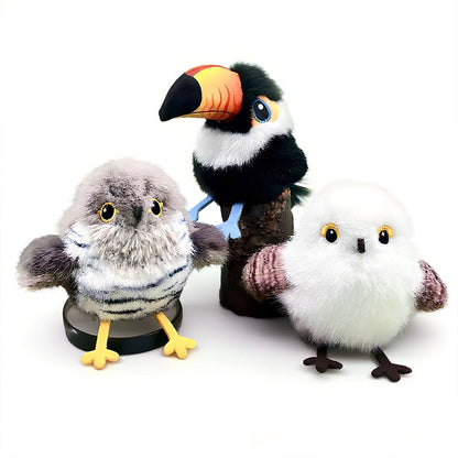 Three plush toys of an owl, toucan, and penguin on a white background